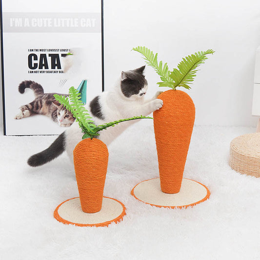 Cat playing with carrot-shaped scratching posts on a white surface.