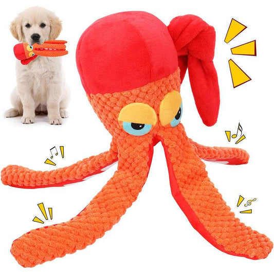 Dog playing with a red and orange octopus-shaped toy.