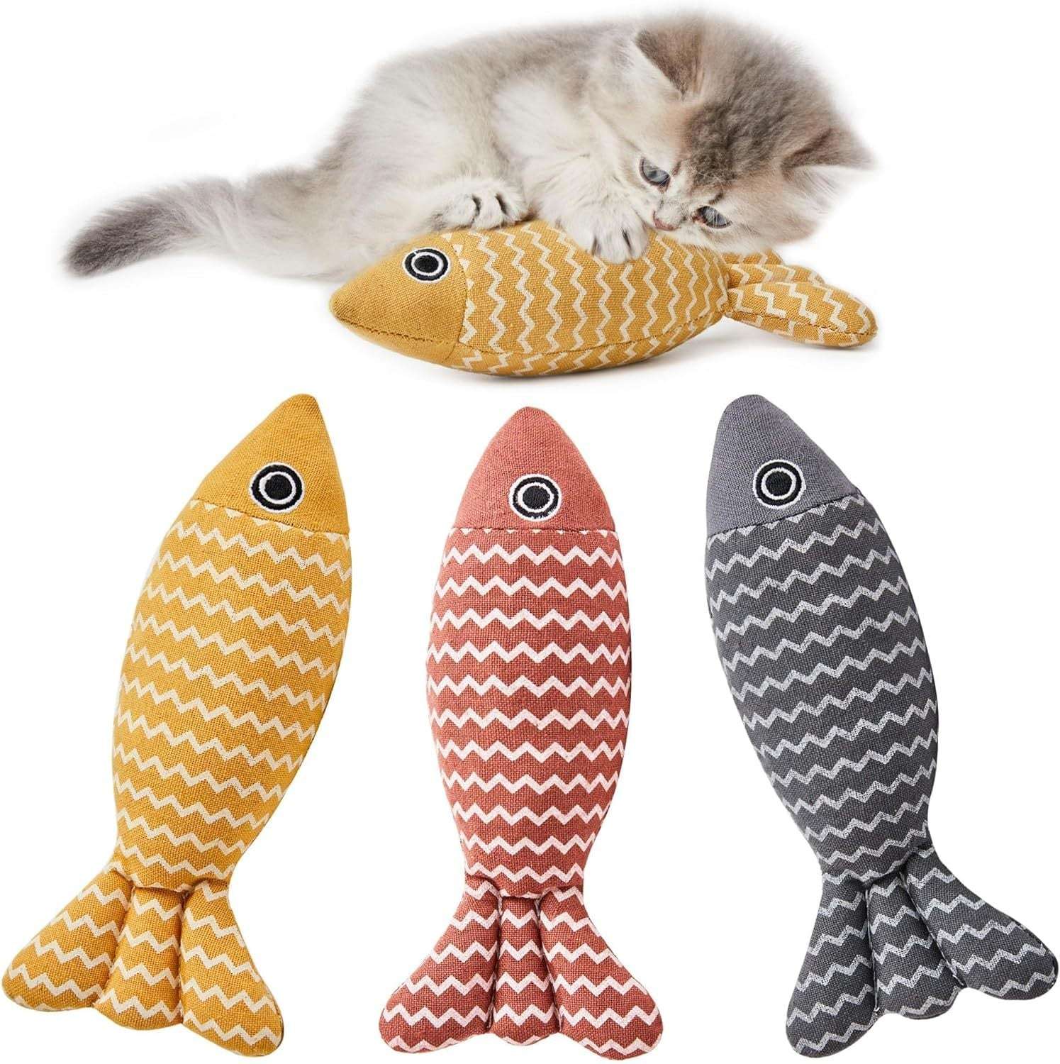 Three fish-shaped cat toys with chevron patterns and a cat playing with one of them.