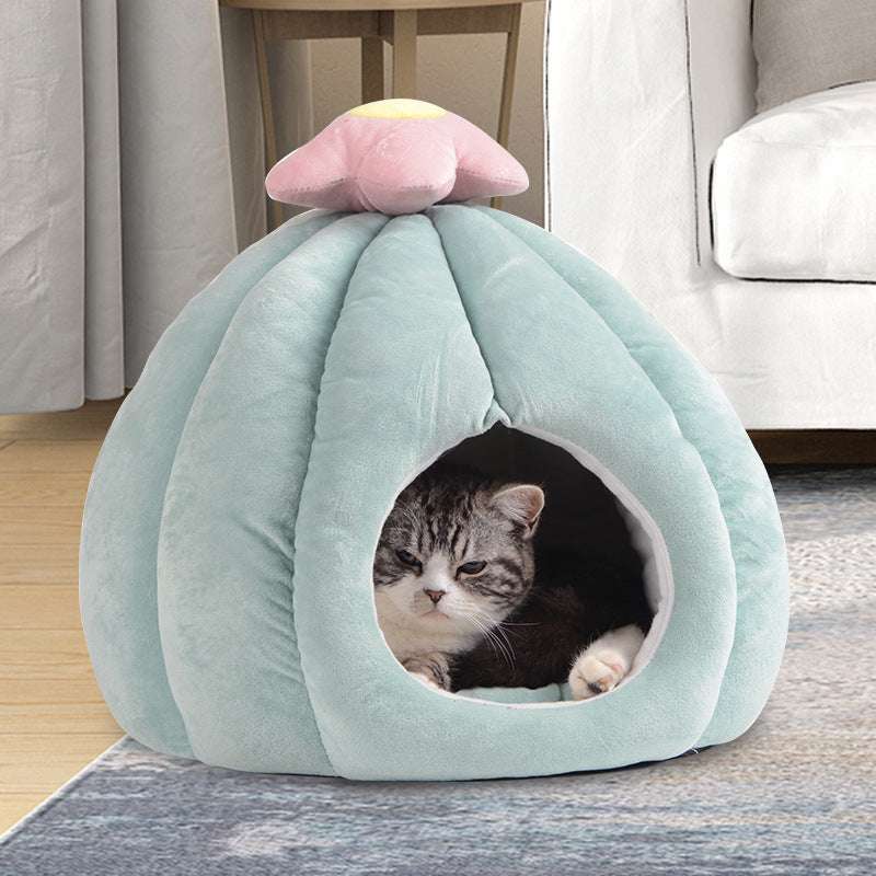 Cat peeking out from a light blue pet bed shaped like a cloud with a pink cloud on top, in a home setting.