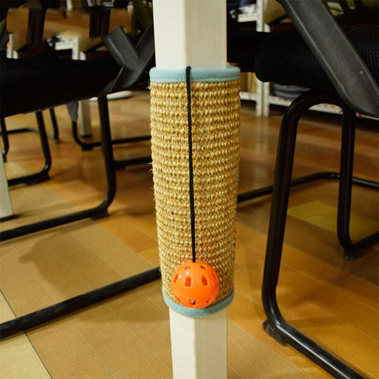 Cat toy with orange ball attached to a scratching post on a wooden floor.