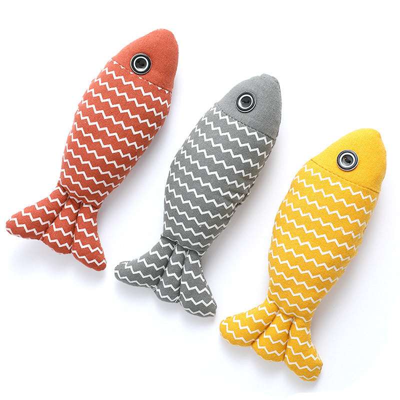 Three fish-shaped toys in orange, gray, and yellow with white zigzag patterns on a white background.