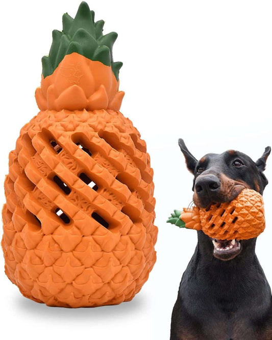 Dog playing with a pineapple-shaped toy on a white background