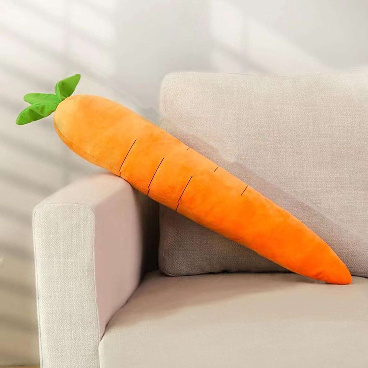 Carrot-shaped pillow on a beige couch with a neutral background