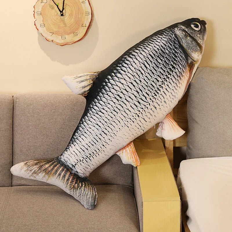Fish-shaped pillow on a sofa with a clock on the wall.