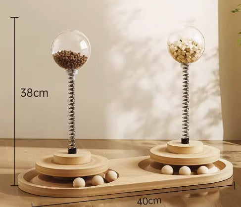 Wooden pet toy with spherical compartments and springs, on a neutral background.
